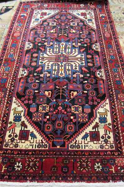 Appraisal: PERSIAN TRIBAL CARPET hand knotted in an overall stylized floral