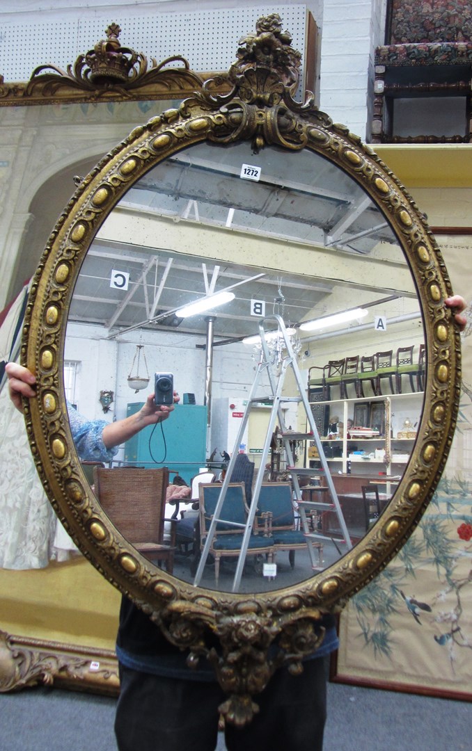 Appraisal: A Victorian oval gilt framed wall mirror with cartouche crest