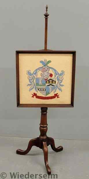 Appraisal: Mahogany pole screen th c with needlepointed coat of arms