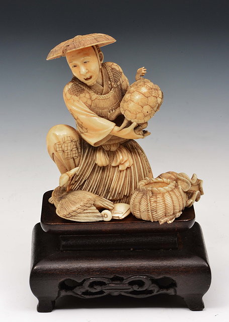 Appraisal: A Japanese ivory okimono of a fishermanMeiji periodsigned Toshi Nori