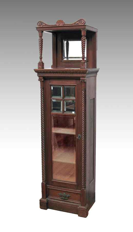 Appraisal: th C CARVED WALNUT CURIO DISPLAY TOWER Featuring beveled mirrors