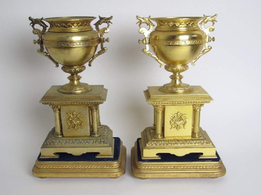 Appraisal: A pair of Victorian brass side urns on pillar bases