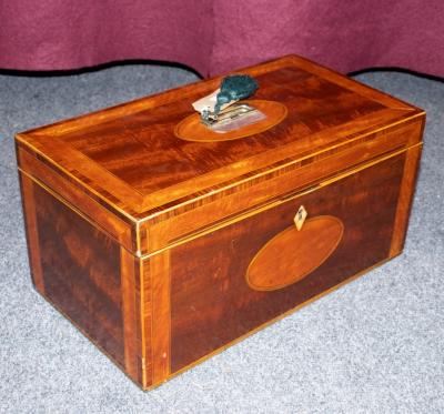 Appraisal: A Georgian mahogany tea caddie cross banded in satinwood fitted