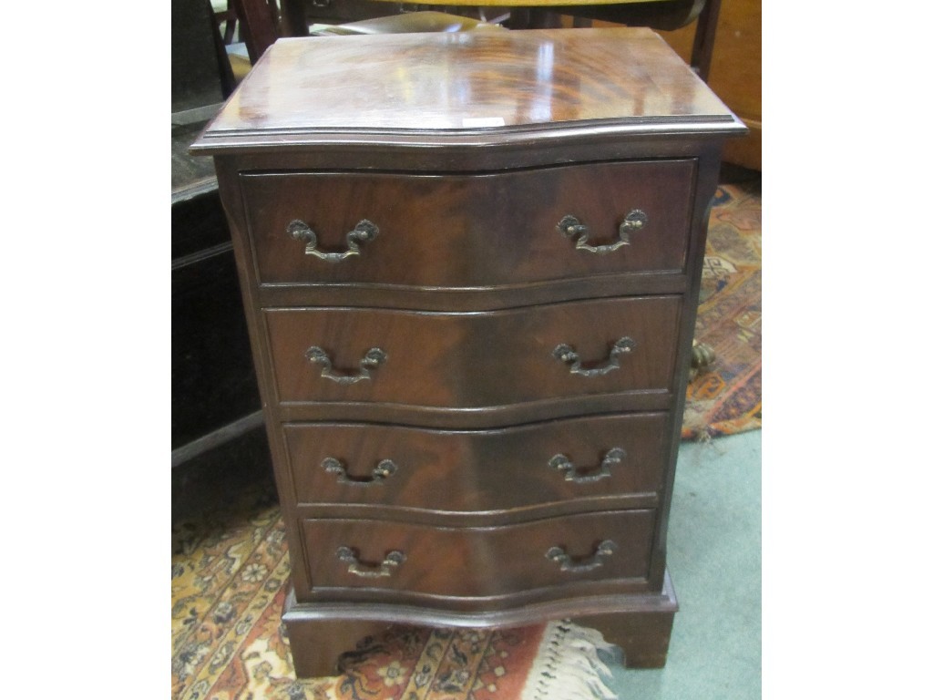 Appraisal: Reproduction serpentine shaped chest of drawers