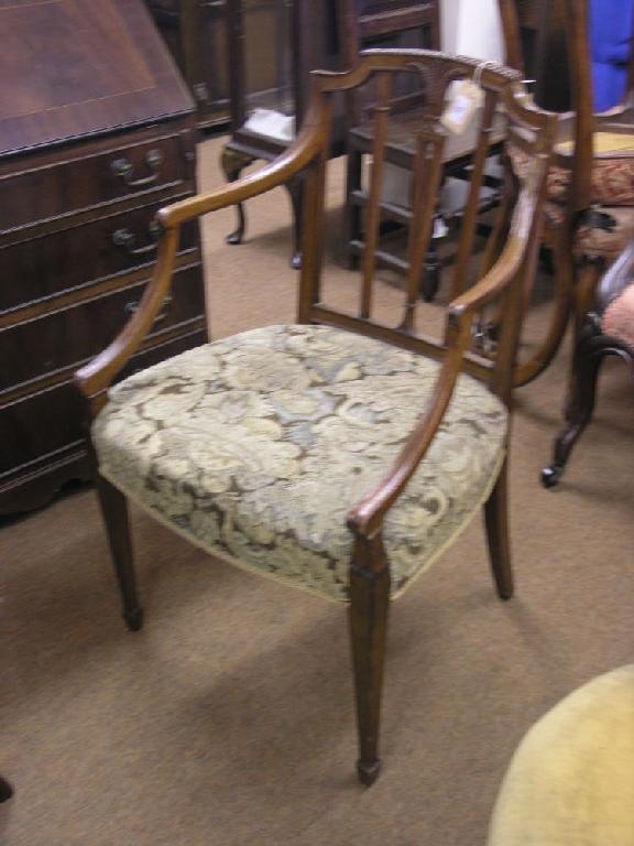 Appraisal: A Sheraton period mahogany elbow chair the back carved with