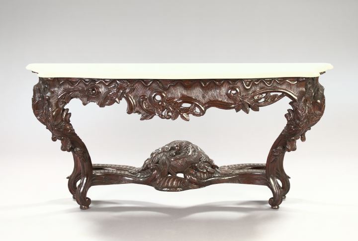 Appraisal: Pair of Exuberantly Modeled Carved Mahogany and Marble-Top Consoles in