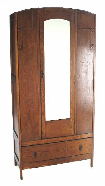 Appraisal: An Arts and Crafts oak armoire with single mirrored door