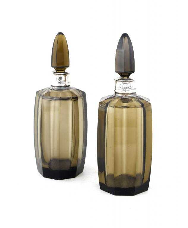 Appraisal: A PAIR OF GEORGE V SILVER MOUNTED SMOKE GLASS BOTTLES