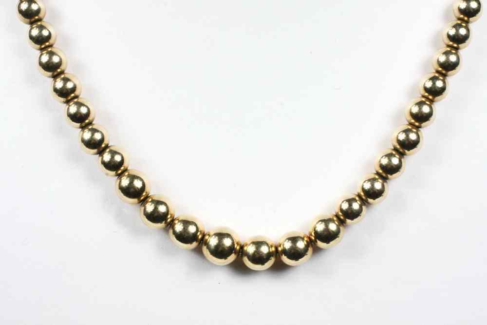 Appraisal: BEAD NECKLACE - One graduated strand of K yellow gold