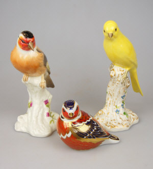 Appraisal: Two Royal Worcester songbirds on naturalistic formed pedestals nos to