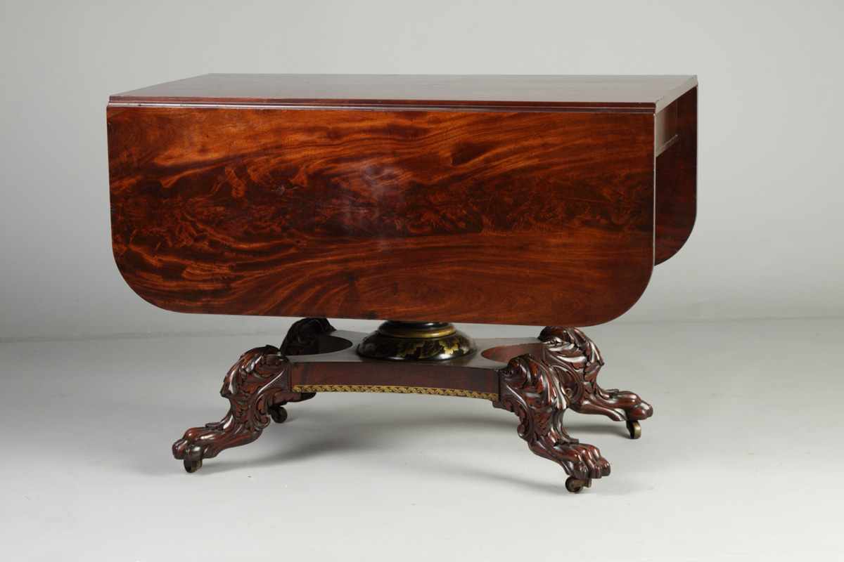 Appraisal: Empire Mahogany Drop Leaf Table Carved paw feet Stenciled column