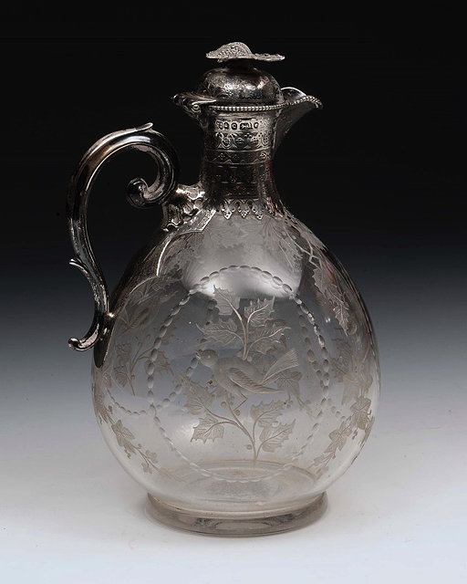 Appraisal: A VICTORIAN SILVER MOUNTED GLASS CLARET JUG with engraved birds