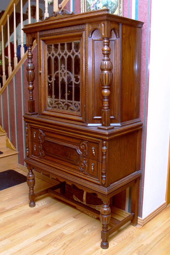 Appraisal: JACOBEAN STYLE CARVED OAK CHINA CABINET Carved crest with finial