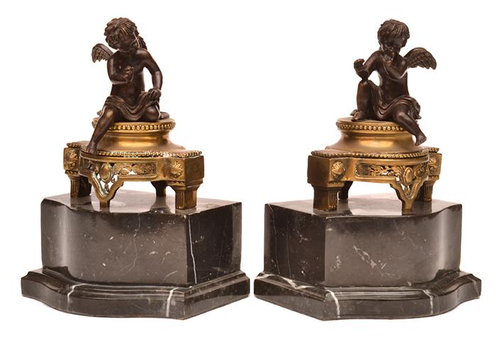 Appraisal: PAIR OF BRONZE AND GILT CUPIDS MOUNTED ON BLACK MARBLE