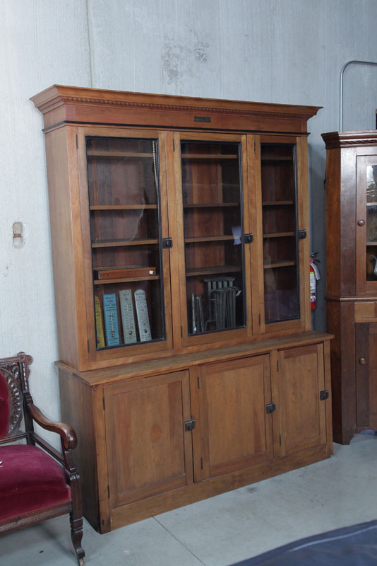 Appraisal: TWO PIECE HARDWARE CABINET Walnut having a dentil carved cornice