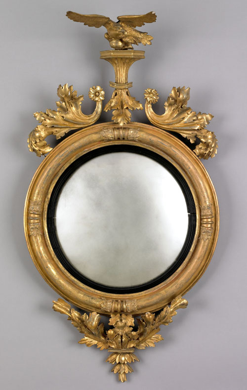 Appraisal: Giltwood convex mirror ca with a spread winged eagle crest