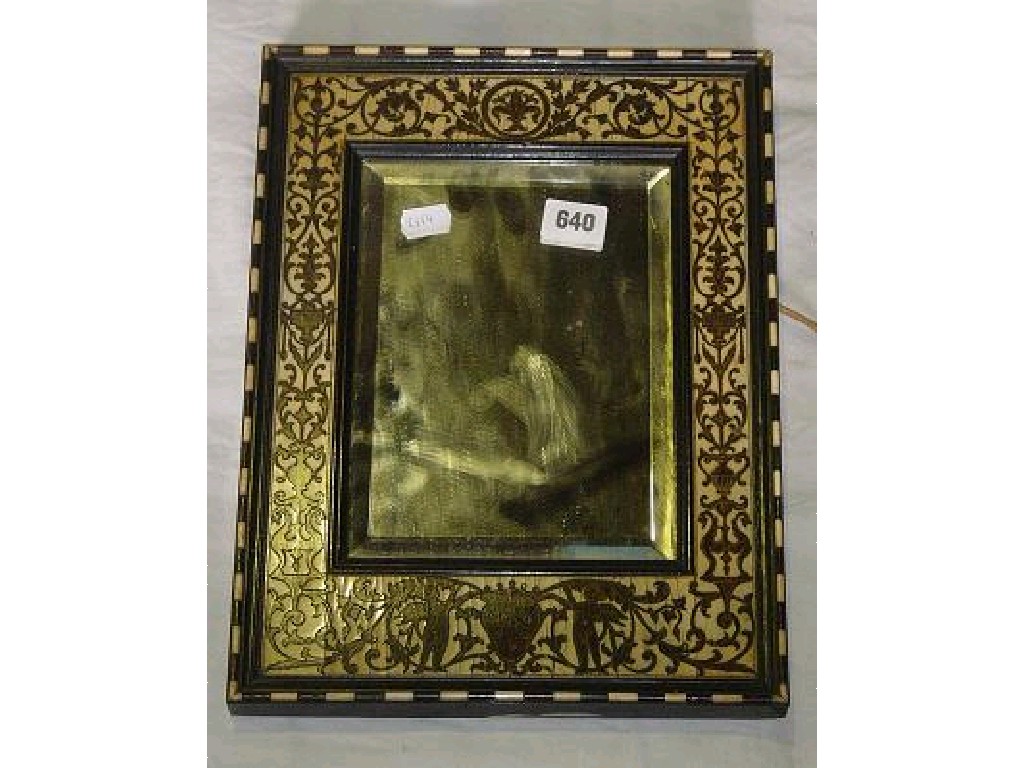 Appraisal: A mirror in an ornate frame inlaid with ebony and