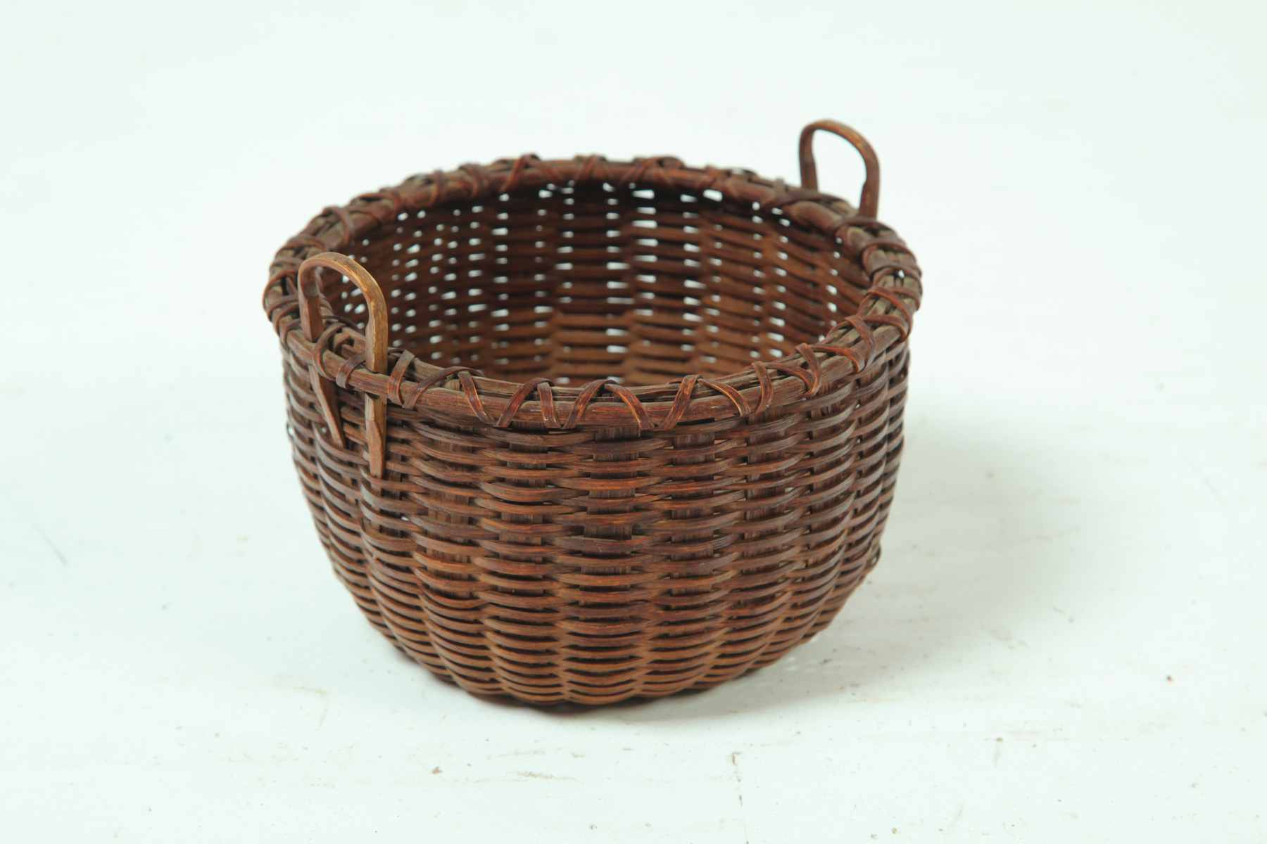 Appraisal: NANTUCKET BASKET Massachusetts late th century Round with carved handles