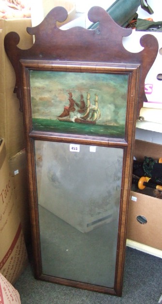 Appraisal: A walnut fret cut wall mirror painted with a ship