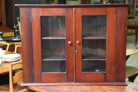 Appraisal: HANGING CUPBOARD Cherry having two glazed doors with wooden pulls