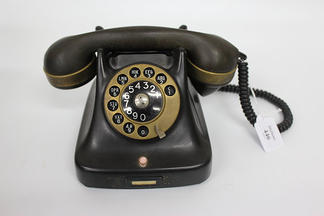 Appraisal: AN OLD BEKELITE AND BRASS MOUNTED TELEPHONE the handset marked