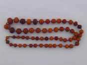 Appraisal: A graduated amber bead necklace largest beads approx mm smallest