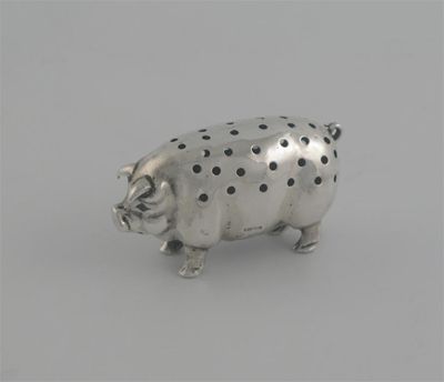 Appraisal: An Edwardian pig pin cushion standing with perforations in its'