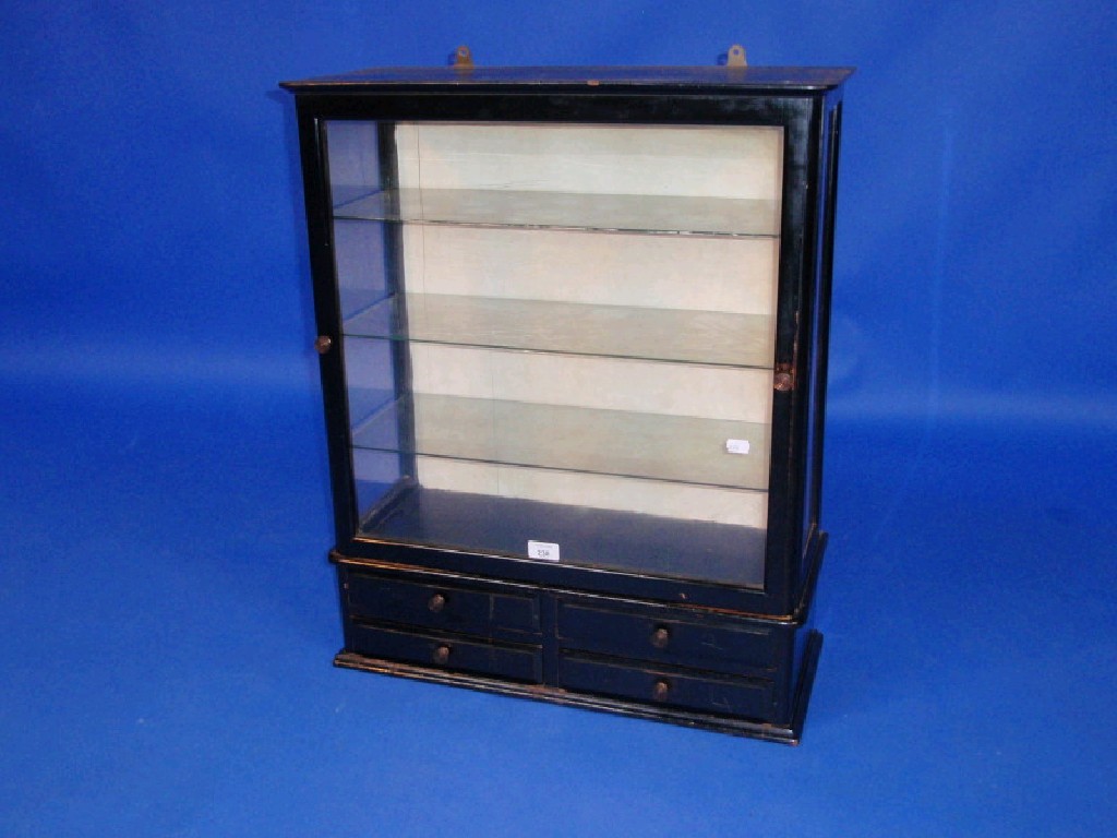 Appraisal: A Victorian ebonised wall cabinet with glazed upper part and