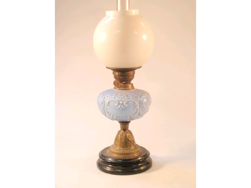 Appraisal: A thC oil lamp with a blue opaque glass reservoir