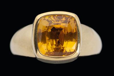 Appraisal: Golden sapphire solitaire ring square faceted cushion sapphire estimated weight