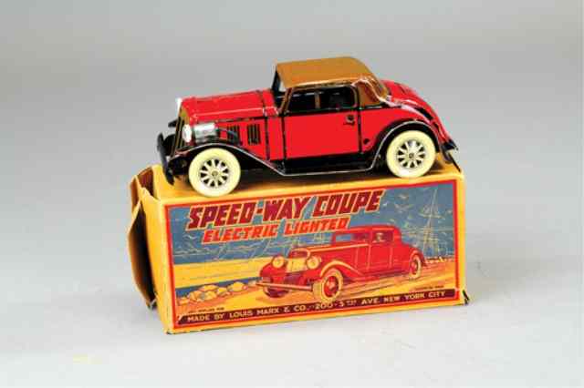 Appraisal: MARX BOXED SPEEDWAY COUPE Lithographed tin electric lights red body