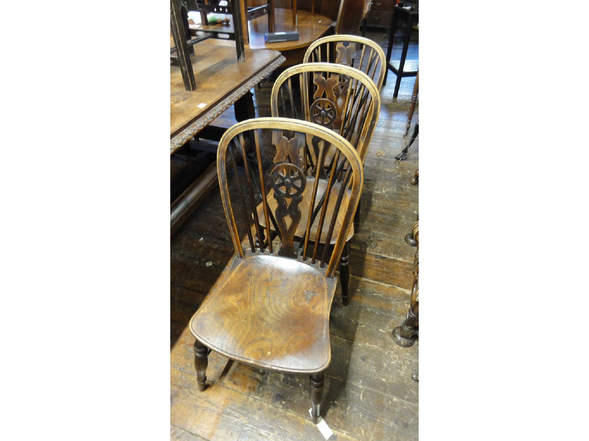 Appraisal: A set of three antique Windsor wheel back kitchen chairs