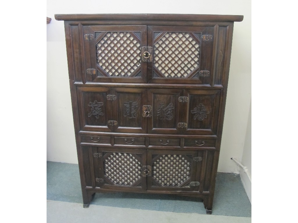 Appraisal: An oriental hardwood cupboard chest decorated with Chinese symbols cm