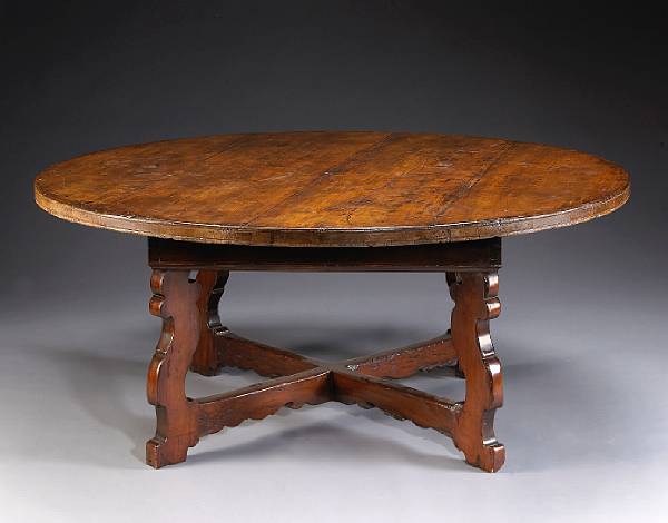 Appraisal: An Italian Baroque walnut dining table The circular top on