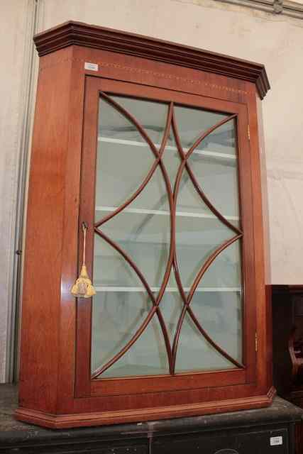 Appraisal: A GEORGIAN MAHOGANY HANGING CORNER CABINET with painted interior enclosed