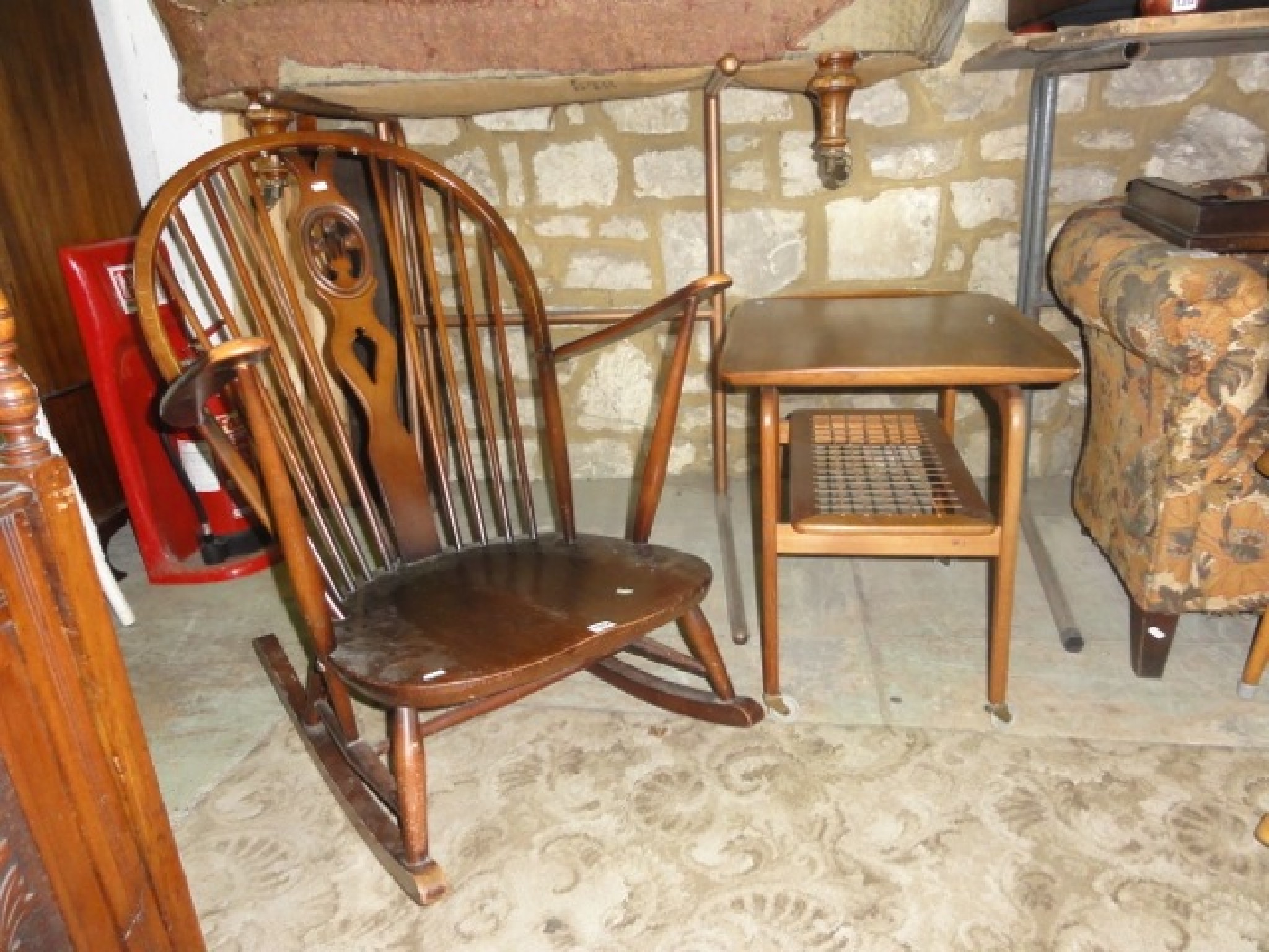 Appraisal: A Ercol dark stained low hoop and stick back rocking