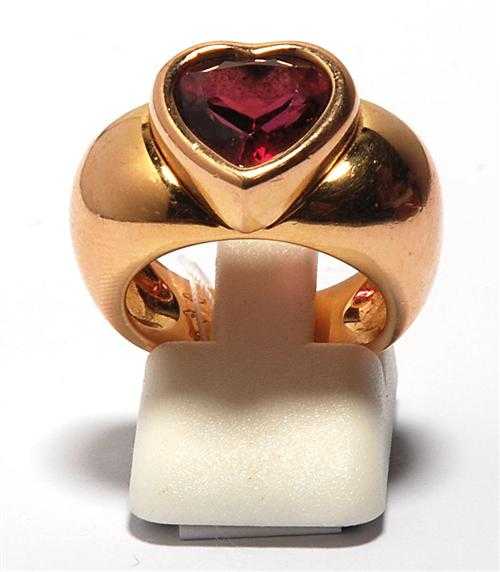 Appraisal: GARNET AND GOLD RING PIAGET ca Ros gold Casual ring