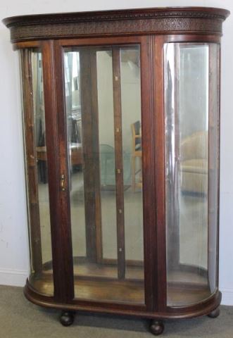 Appraisal: Oak Curved Glass China Cabinet Nicely carved crown raised on