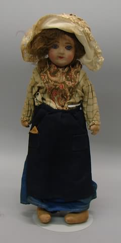 Appraisal: Unmarked cloth mask face doll with stationary blue glass eyes