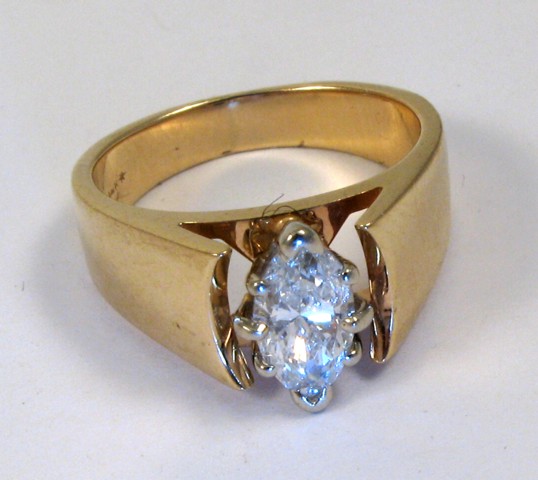 Appraisal: DIAMOND AND FOURTEEN KARAT GOLD RING centering a marquise-cut diamond