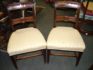 Appraisal: Four Regency mahogany dining chairs with pierced carved backs above