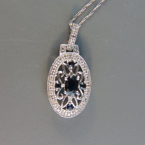 Appraisal: Sapphire Diamond Pendant oval and round deep blue gems surrounded