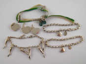 Appraisal: A mixed lot comprising three silver charm bracelets a silver