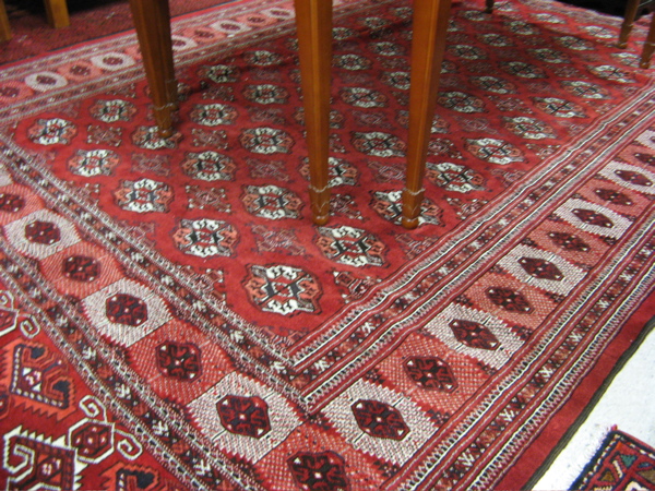 Appraisal: BELOUCHI TURKOMAN CARPET featuring a rectangular red field of repeating