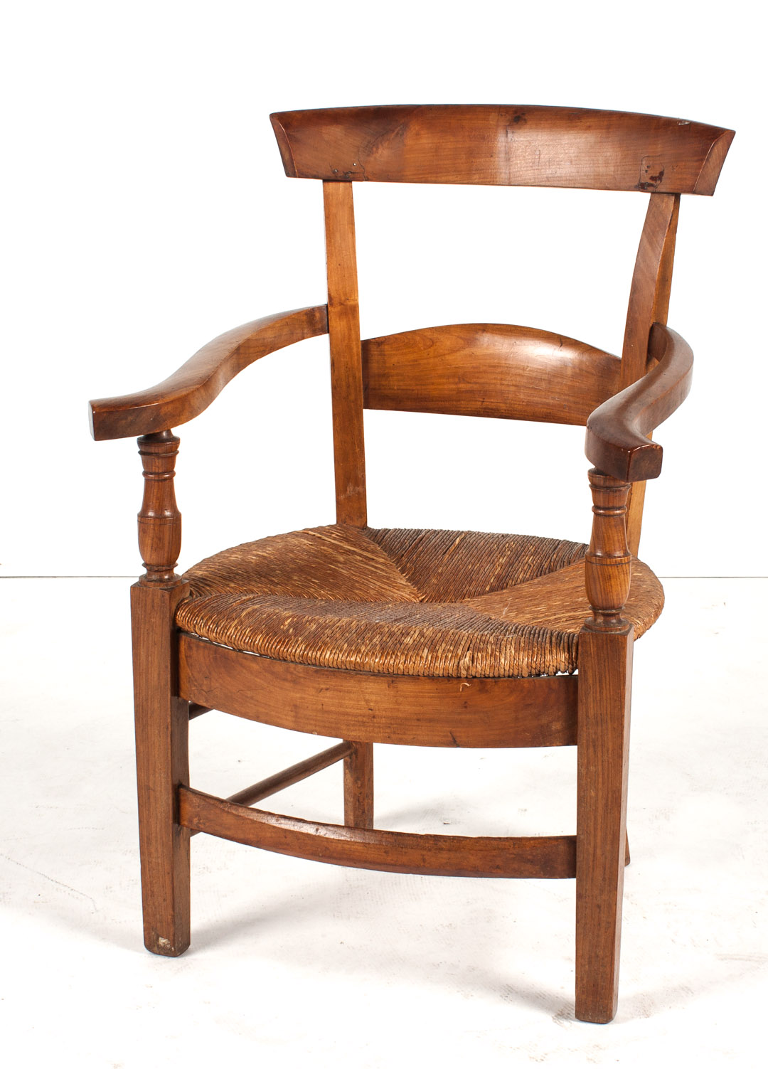 Appraisal: French Provincial fruitwood armchair late th century rush seat in