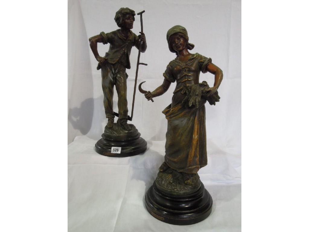 Appraisal: A pair of cast metal statuettes of farm workers one