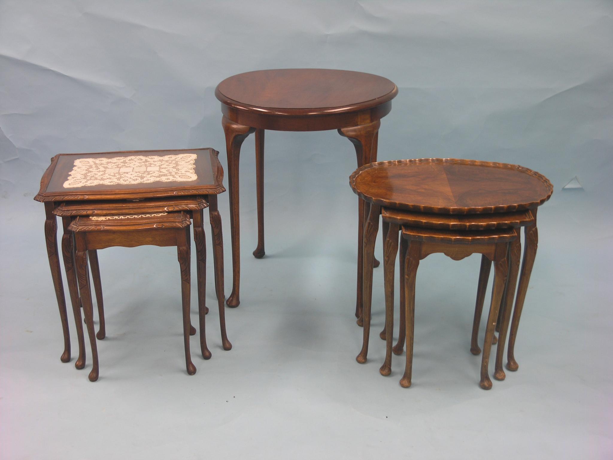 Appraisal: An oval walnut nest of tables with quarter-veneered tops a