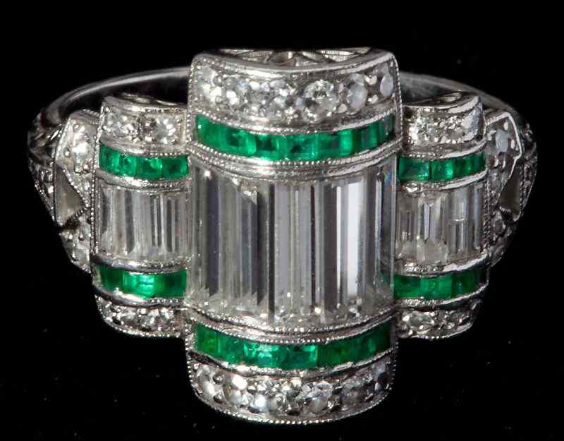 Appraisal: Art Deco Platinum Diamond and Emerald Ringfeaturing diamond baguettes approximately