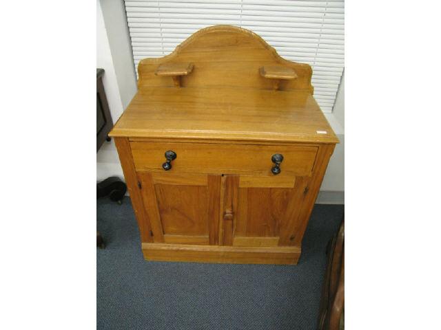 Appraisal: Victorian Chestnut Washstand with candle shelves drawer over double doors