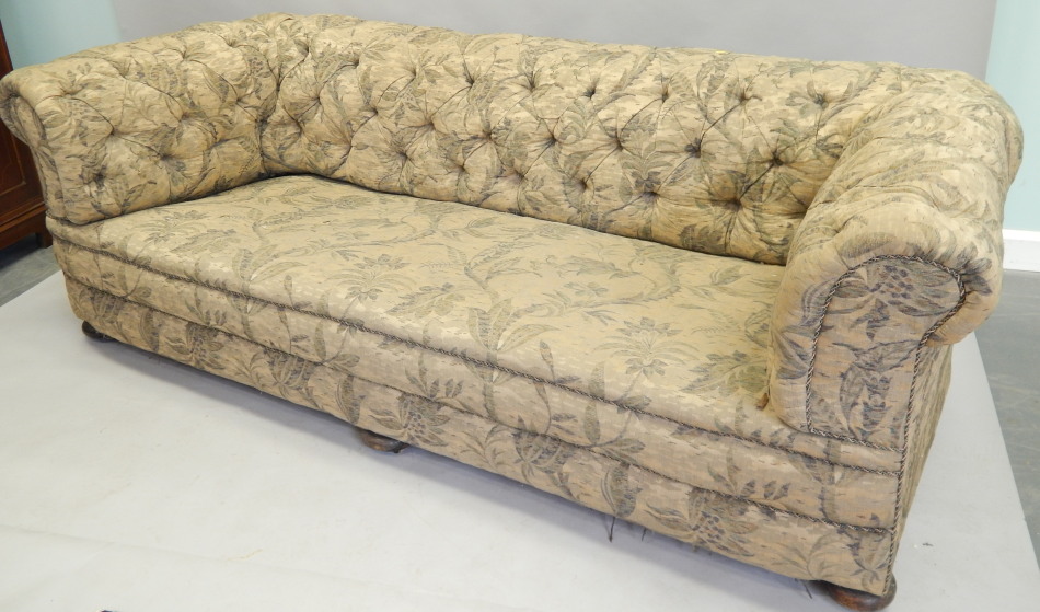 Appraisal: A large Victorian Chesterfield sofa later upholstered in floral fabric